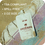 Picture of cocochata body beverage on the beach with the words tsa compliant, spill-free, and 2 oz size