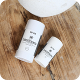 both sizes of Cocochata deodorant on a wood table