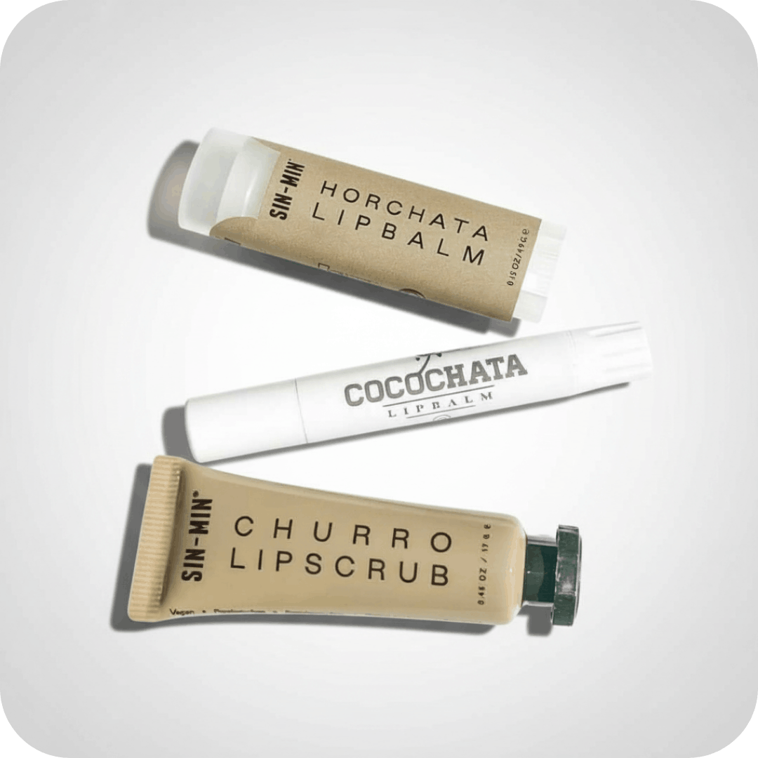 horchata lip balm, cocochata lip balm, and churro lip scrub with a light grey background