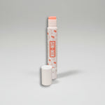 Uncapped strawberry horchata lip balm to show pink lip balm.